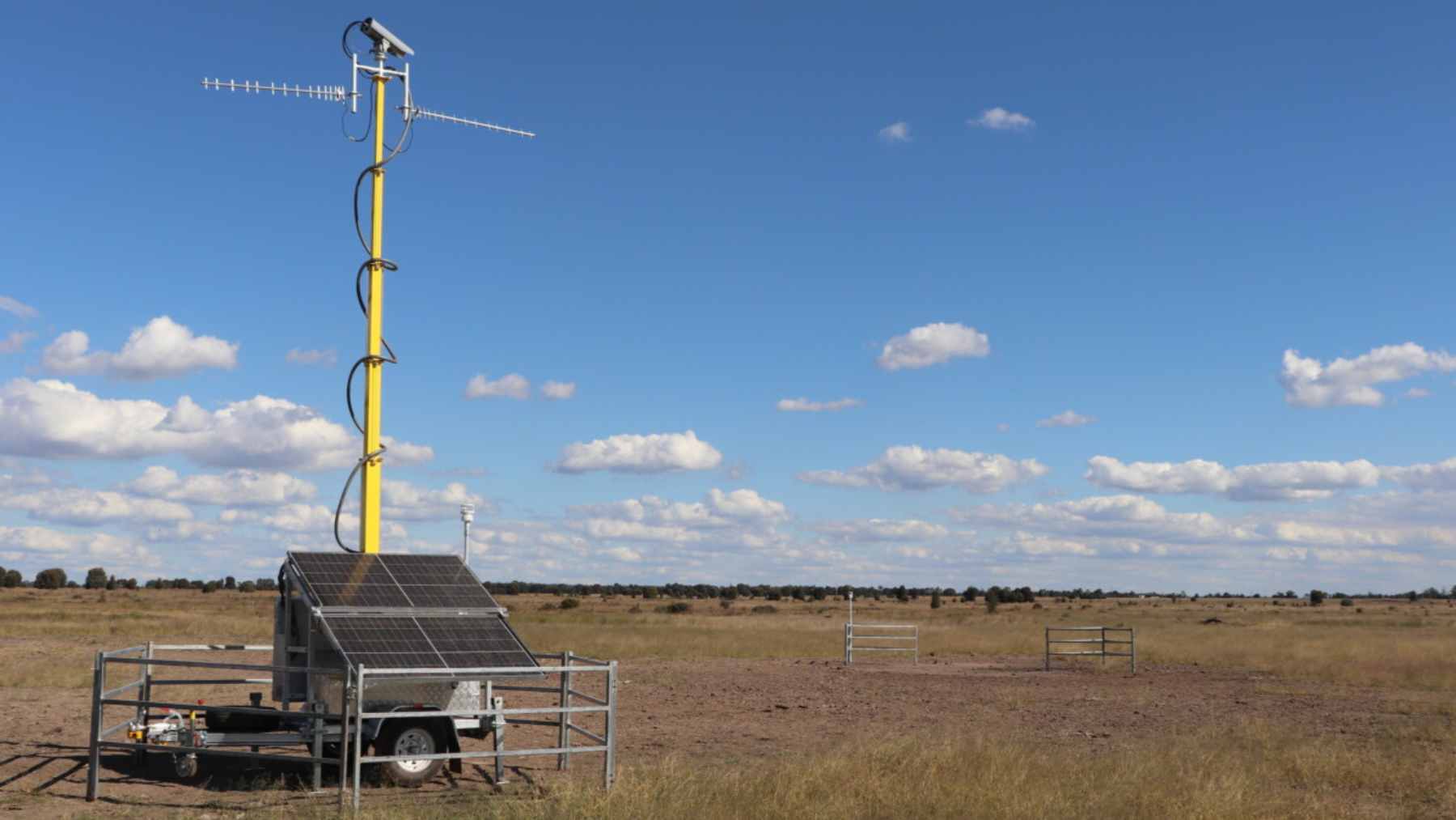 A rusted pipe marking an abandoned coal exploration borehole in a dry Queensland cattle field.