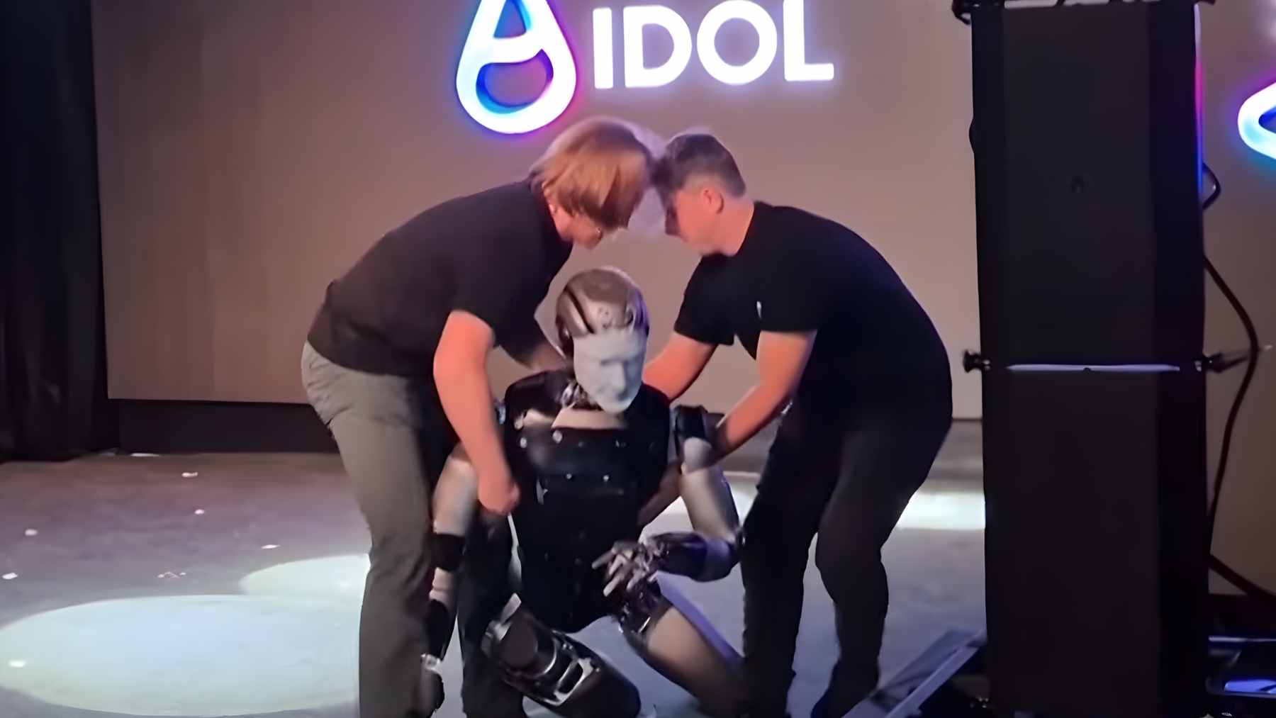 The Russian humanoid robot AIdol falling face-first on a stage at the Yarovit Hall Congress Center in Moscow during a live demonstration.