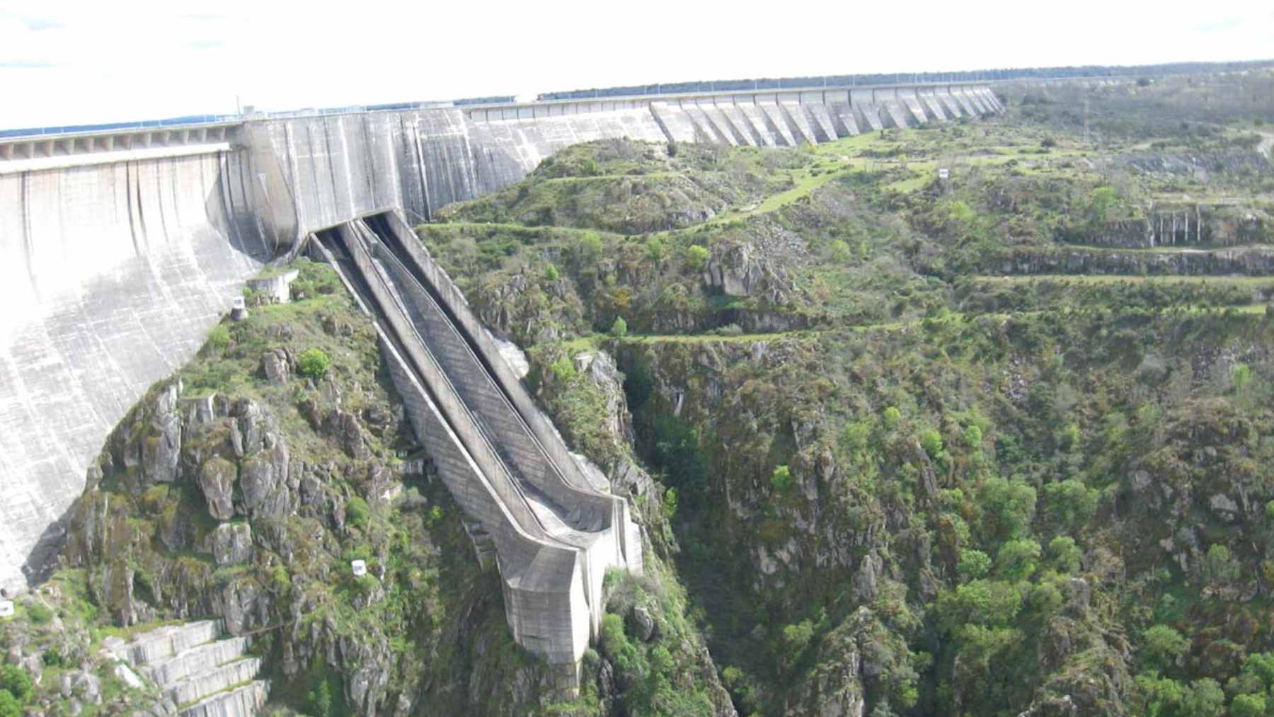 Aerial view of the Almendra Dam's massive concrete arch wall and the Tormes River canyon in Spain.