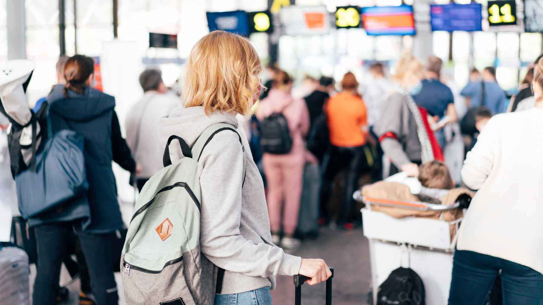 A crowded TSA security checkpoint at a major U.S. airport during a period of high traveler volume and staffing shortages.