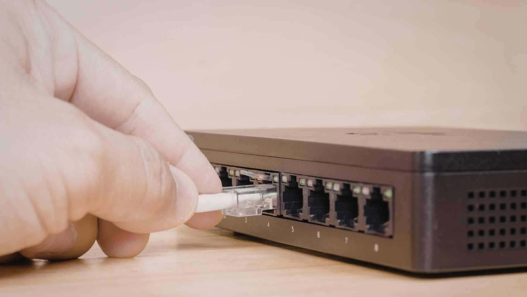 A GIGA Copper G.hn bridge adapter plugged into an older home's telephone wall jack to transmit high-speed internet.