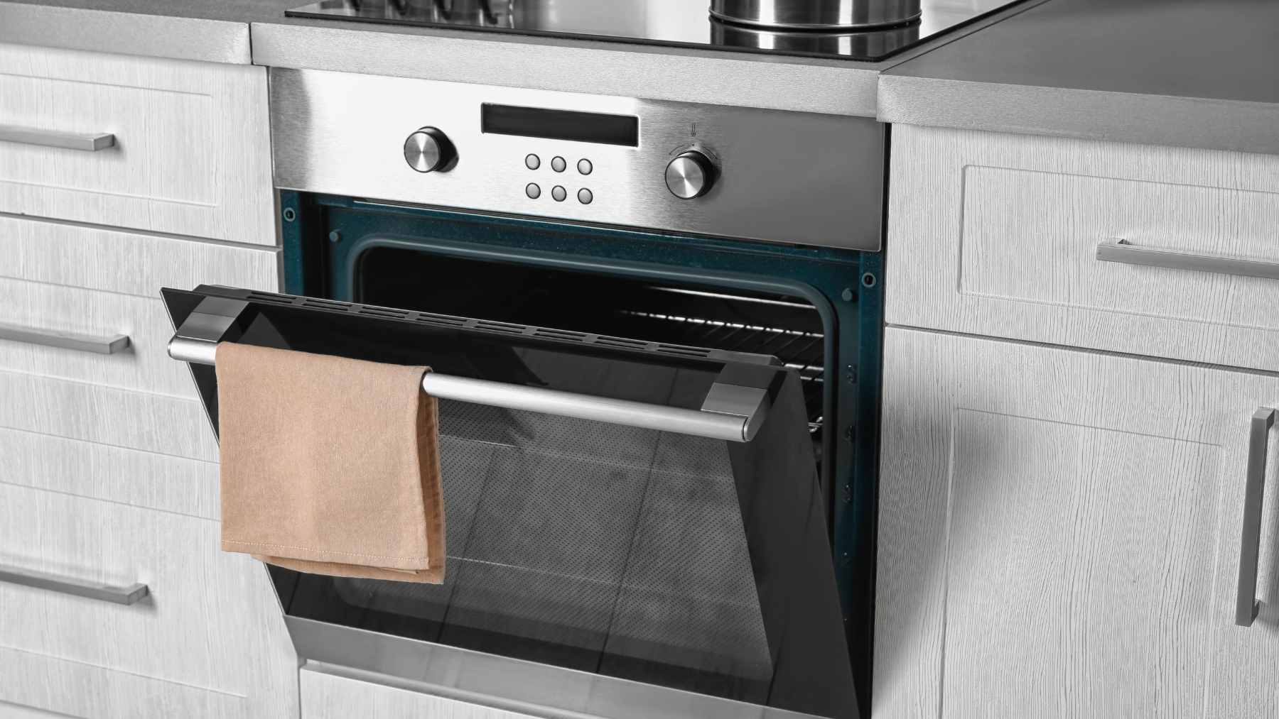 It looks harmless sitting in the kitchen, but this everyday appliance can burn through as much power as 65 refrigerators when it heats up, turning a normal dinner into an expensive hidden drain 1 A close-up of an illuminated electric oven interior with heating elements glowing red, representing high wattage energy consumption.