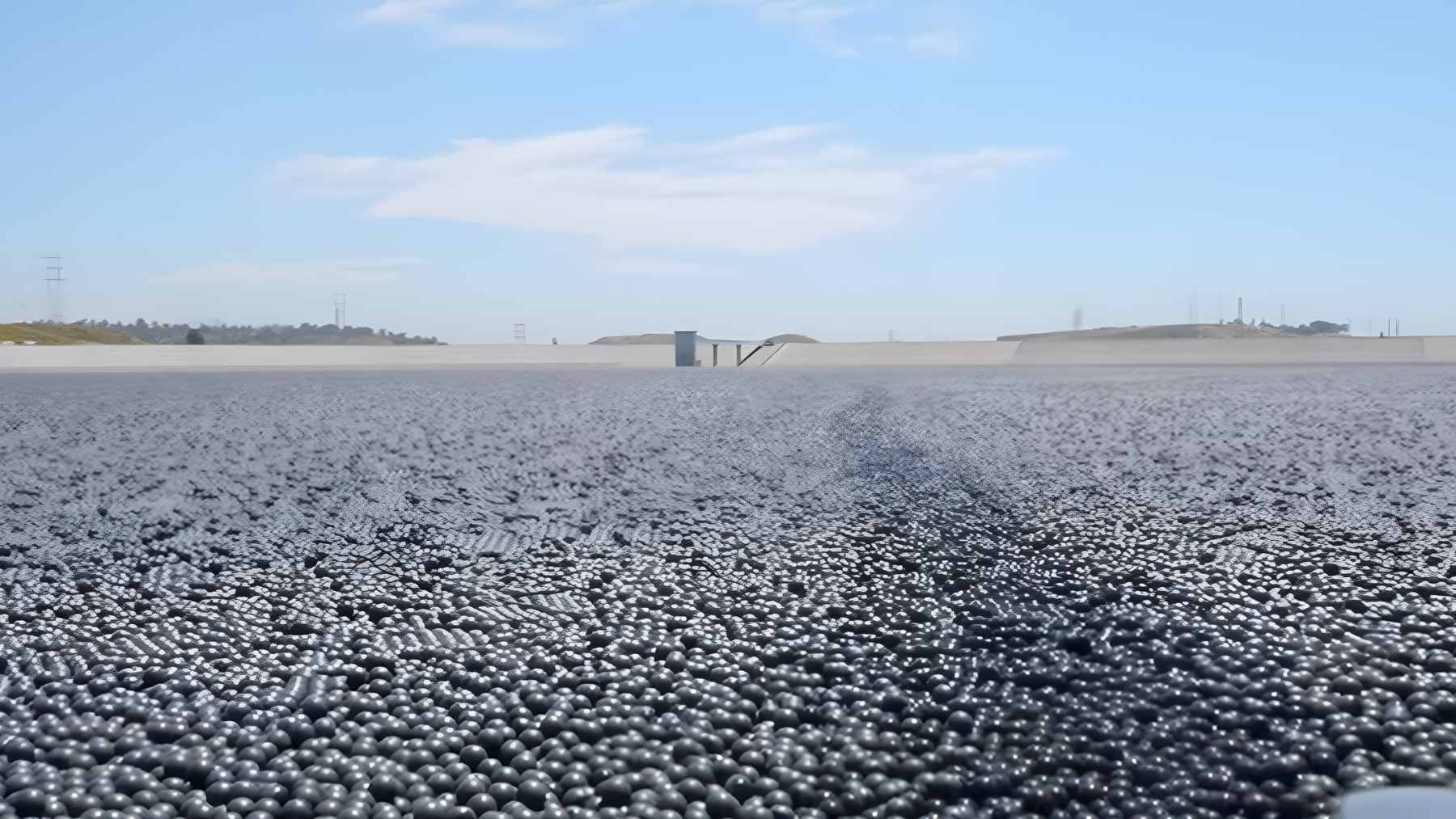 Millions of black plastic shade balls completely covering the surface of the 175-acre Los Angeles Reservoir to protect the water supply.
