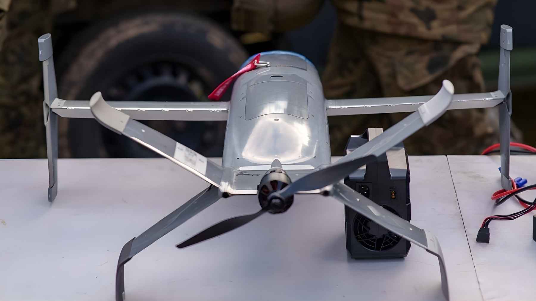 Portable counter-drone aircraft displayed on a table during a military demonstration, illustrating lower-cost air-defense tools gaining attention in Europe