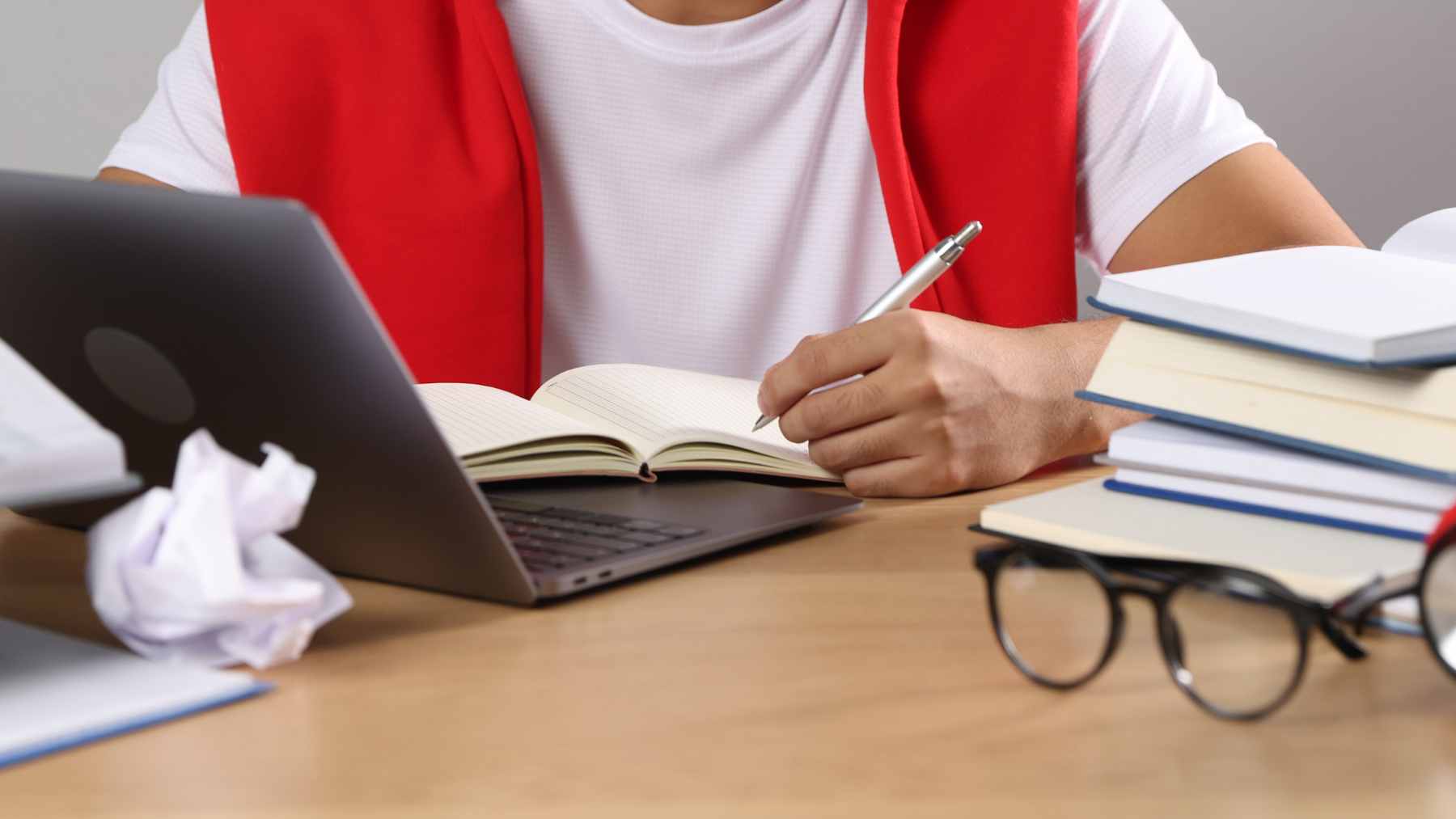 A high school student using a laptop to generate assignments with ChatGPT.