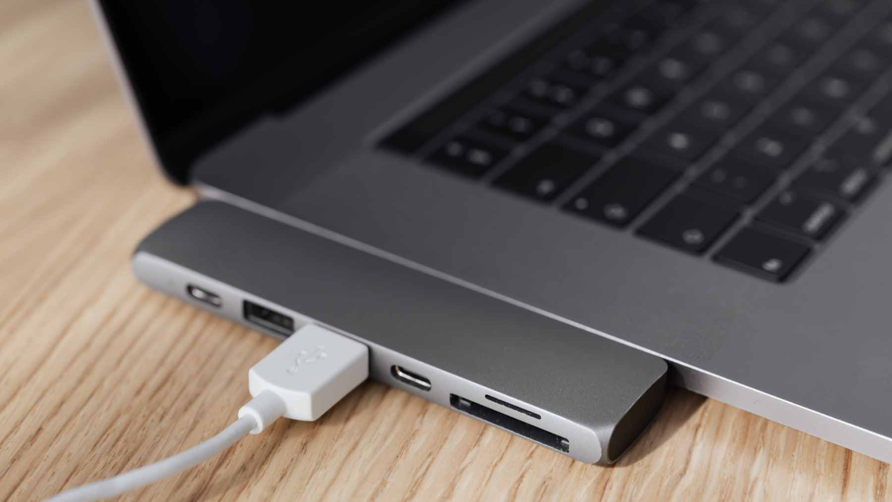 A user connecting a compact USB-C OTG adapter to a smartphone to transfer image files directly to a flash drive.