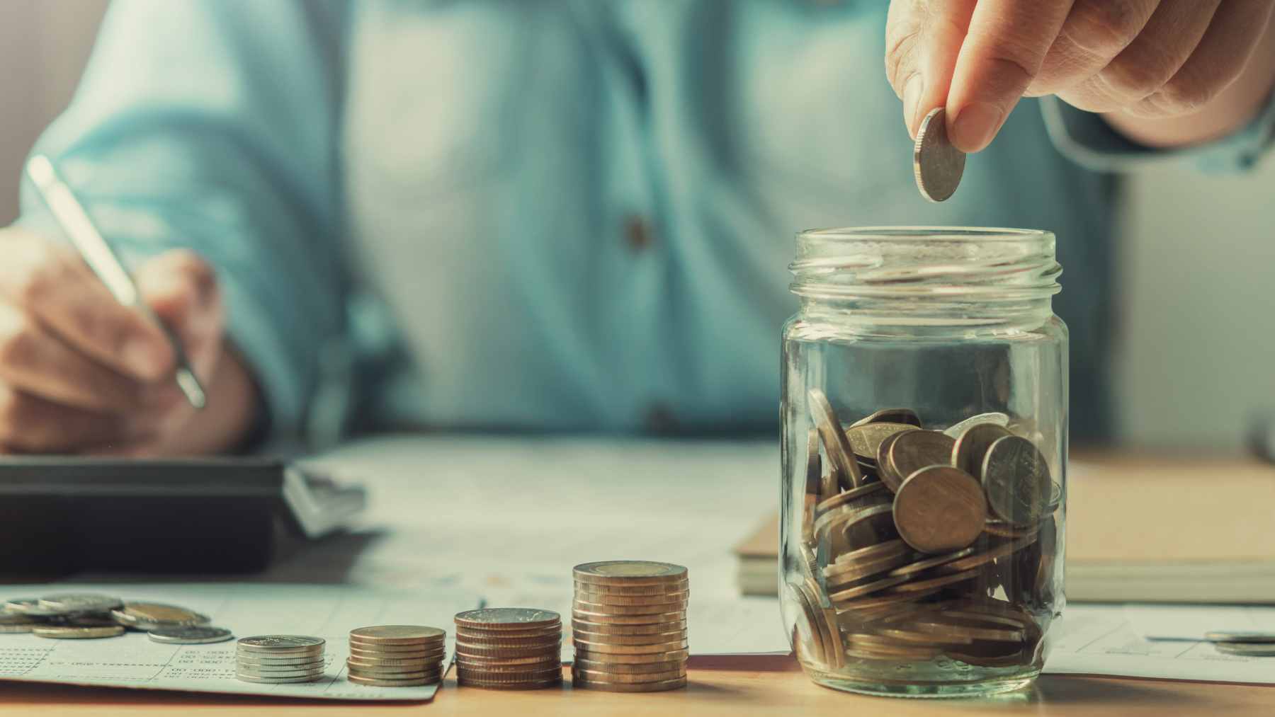 A person at a bank counter presenting a U.S. passport to a teller, illustrating a potential citizenship verification process.
