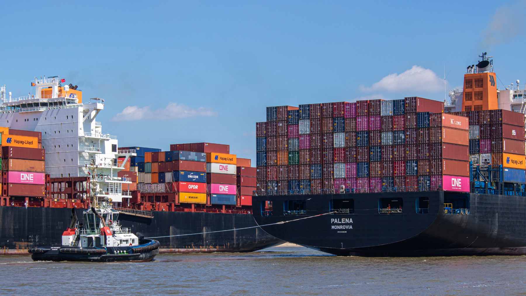 Rows of stacked shipping containers delayed at a U.S. port customs clearance checkpoint due to insufficient bond coverage.