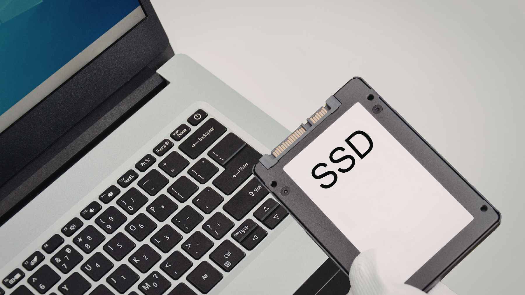 A collection of old USB-A flash drives next to a modern, high-speed USB-C external SSD and a cloud storage icon.