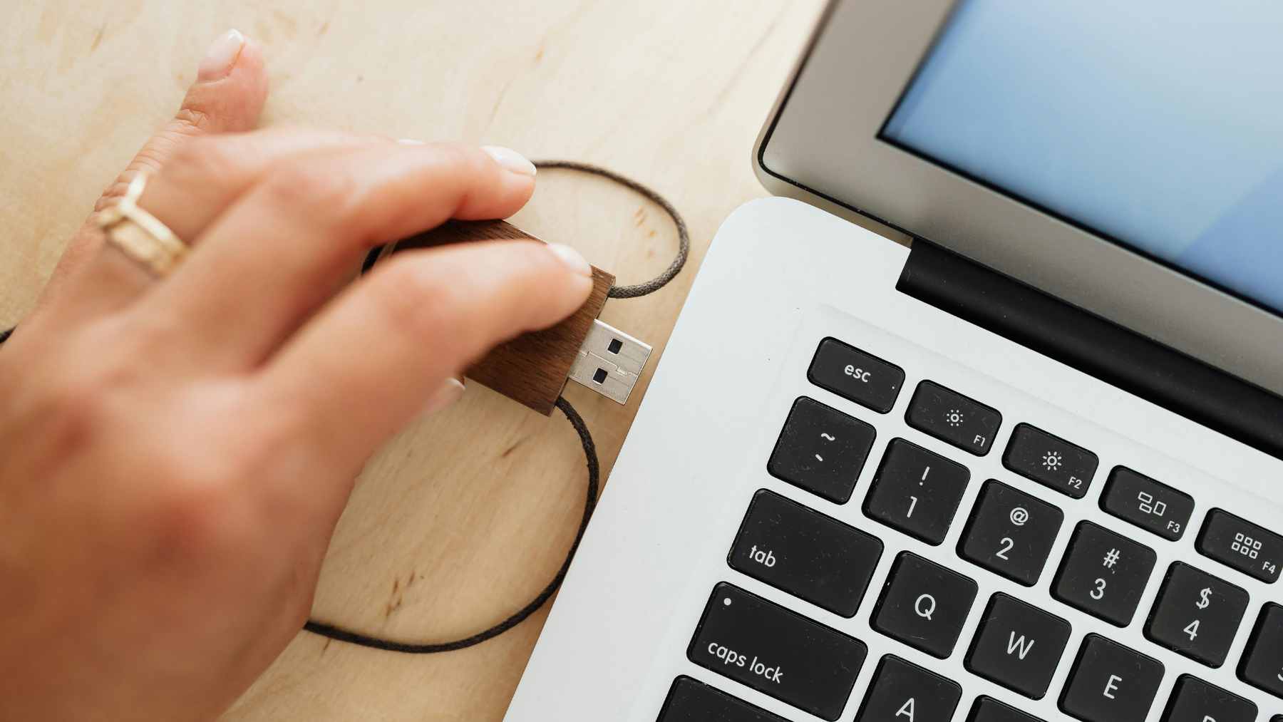 A collection of old USB-A flash drives next to a modern, high-speed USB-C external SSD and a cloud storage icon.