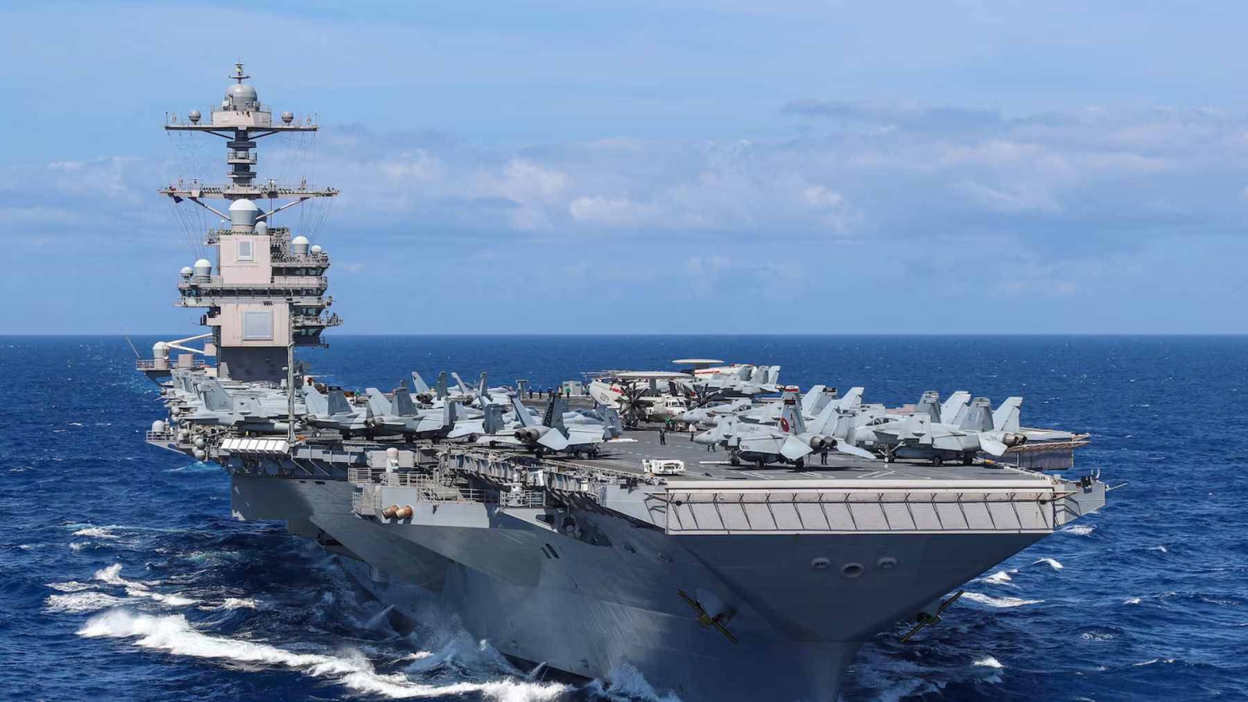 The USS Gerald R. Ford aircraft carrier navigating open waters during its historic 300-day global deployment.