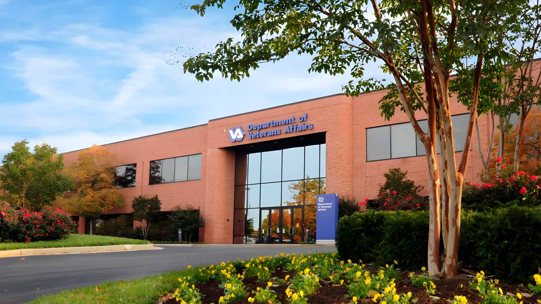 A military veteran sitting at a kitchen table, carefully reviewing a Department of Veterans Affairs disability benefits letter.