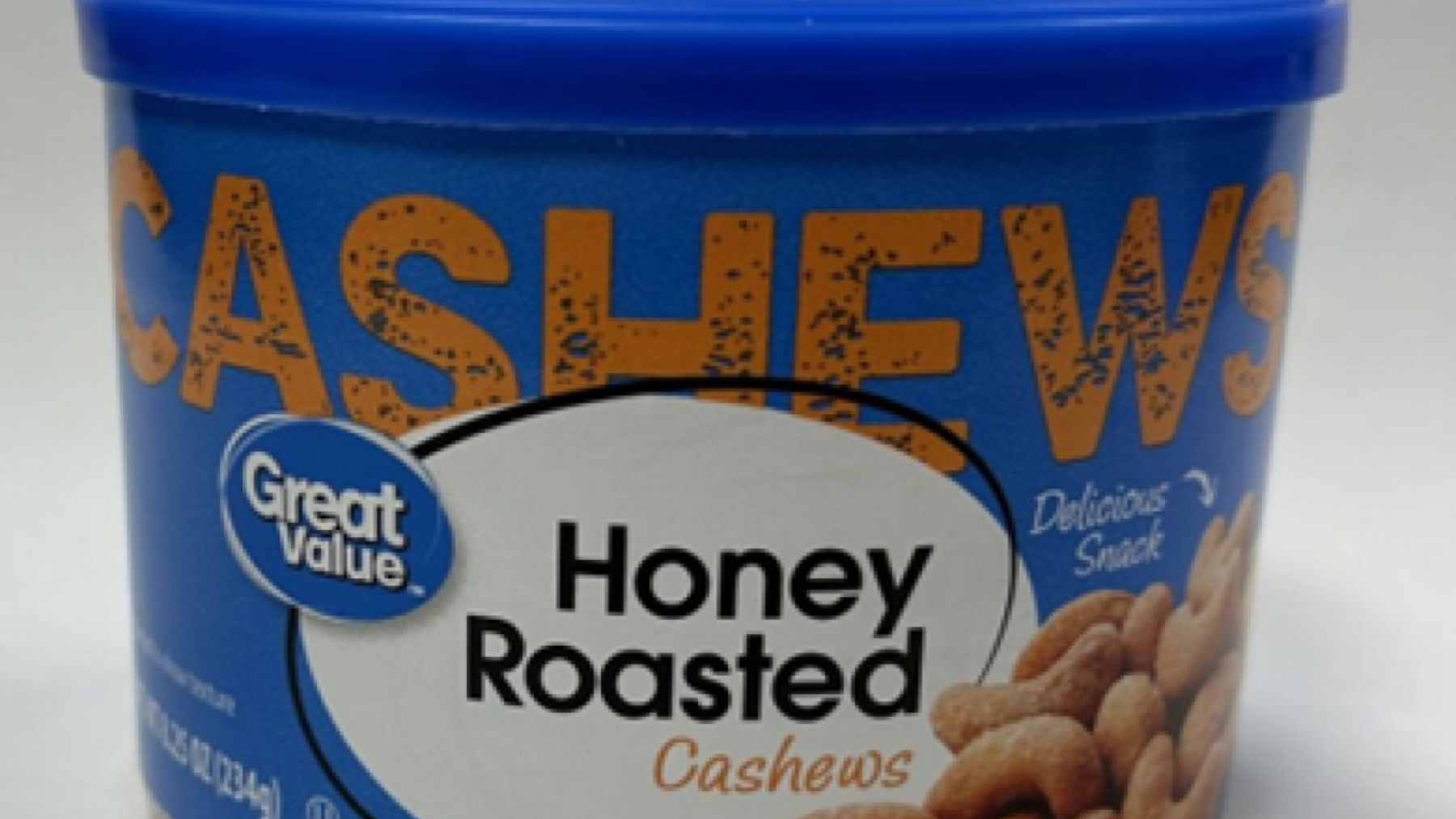 A variety of Walmart Great Value brand grocery products, including milk, cereal, and snacks, displayed on a wooden table.