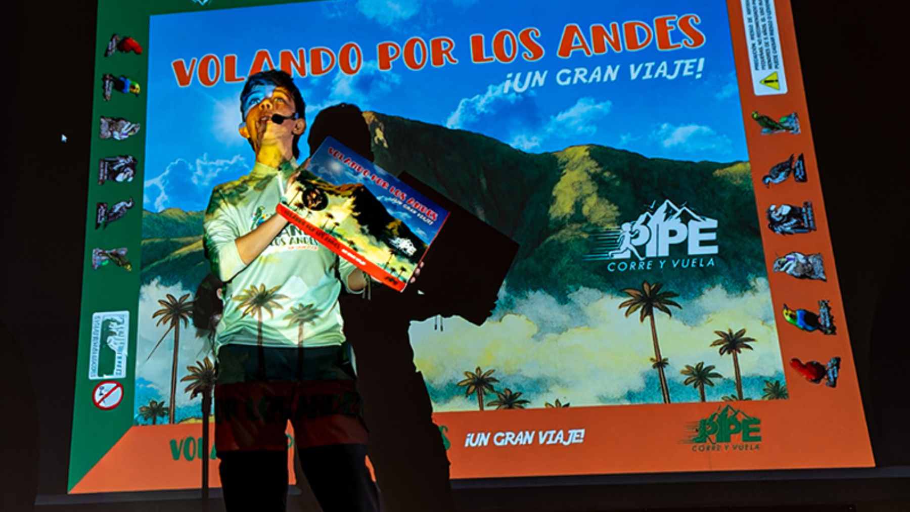 A 14-year-old boy explaining his educational bird conservation board game to a group of interested players.