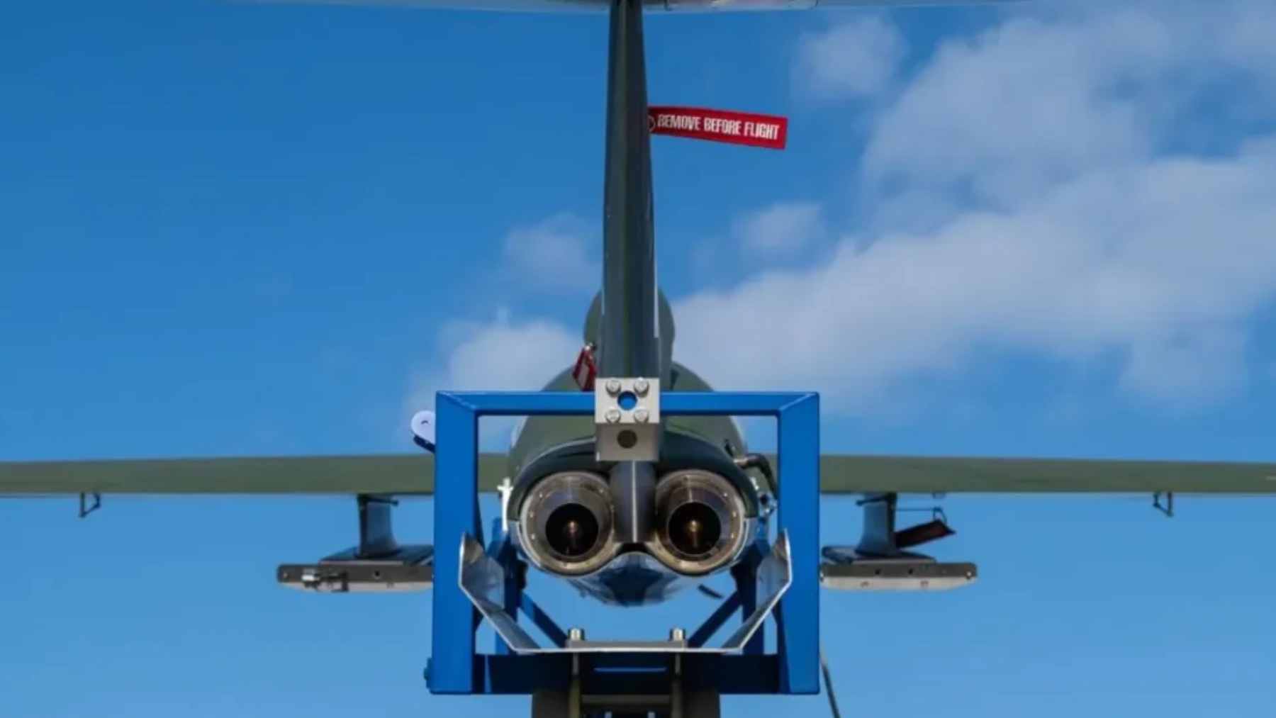 An Airbus Bird of Prey uncrewed interceptor drone in mid-flight carrying small Mark I anti-air missiles under its wings.