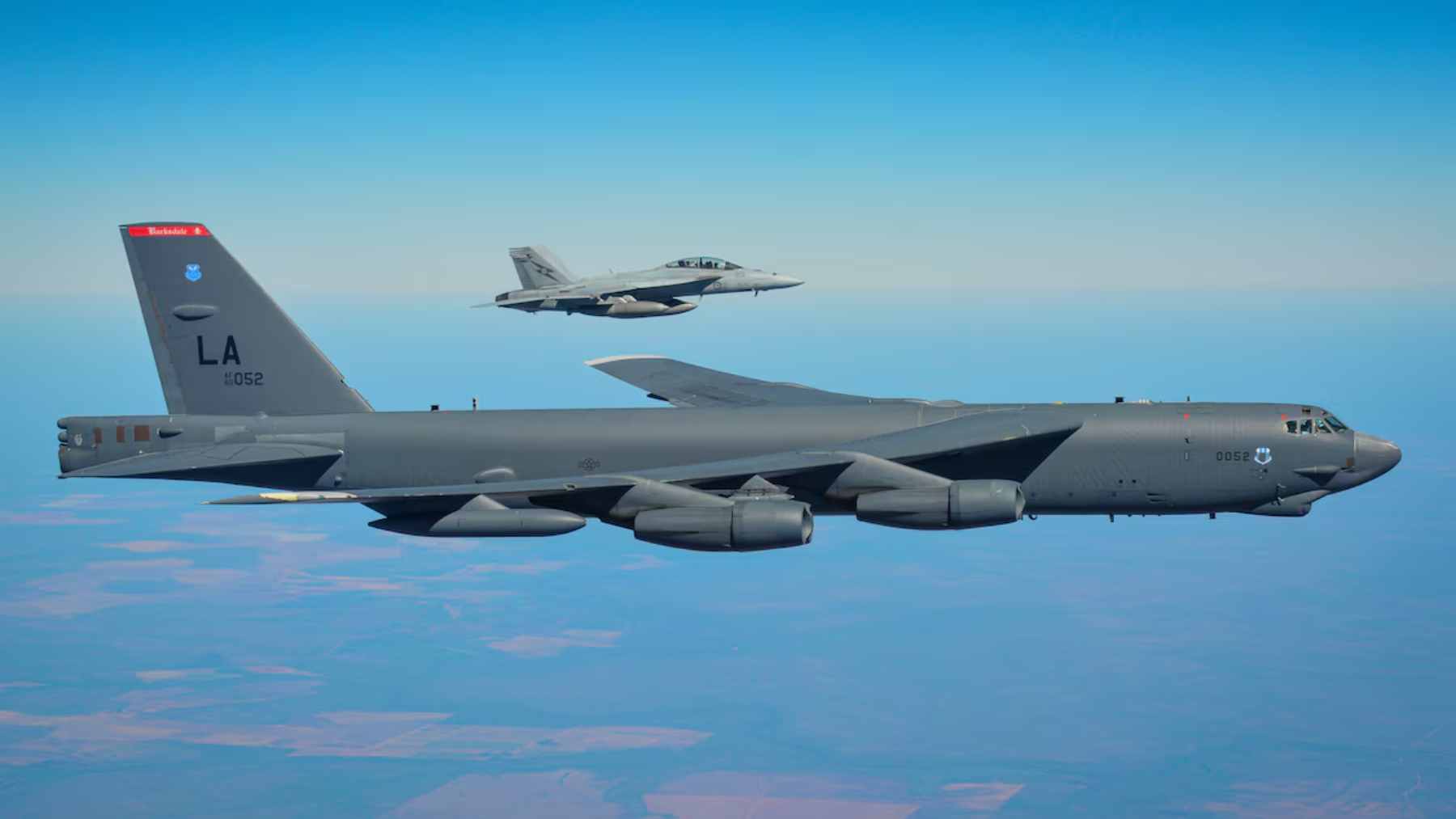 A U.S. Air Force B-52 Stratofortress bomber flying a high-altitude mission through the clouds.