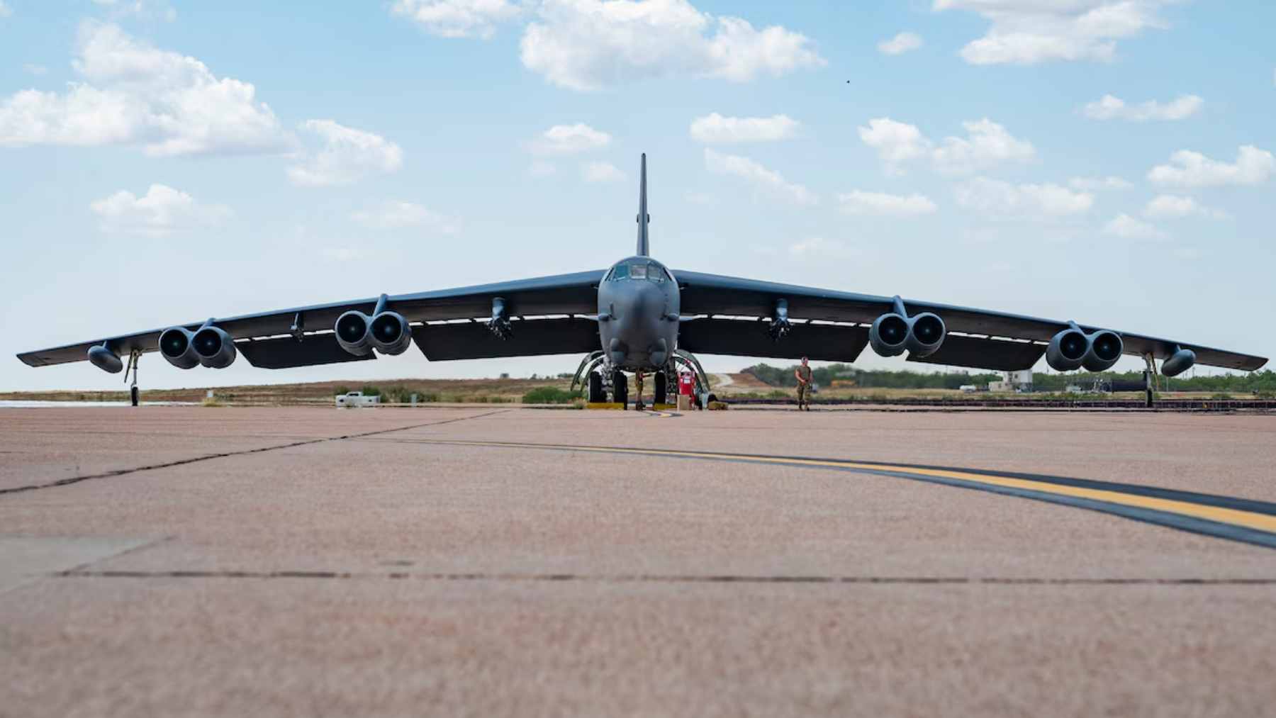 A U.S. Air Force B-52 Stratofortress bomber flying a high-altitude mission through the clouds.