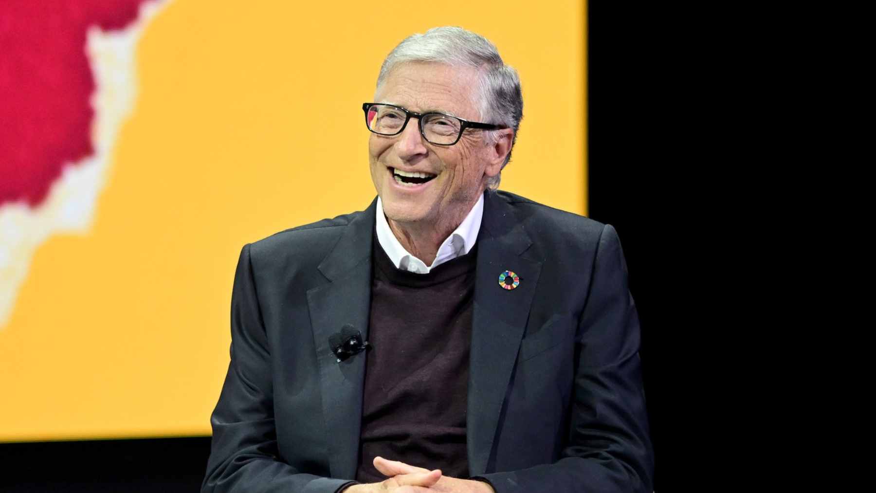 A massive server room in a high-tech data center illuminated by blue LED lights, with thick cooling pipes running along the ceiling.