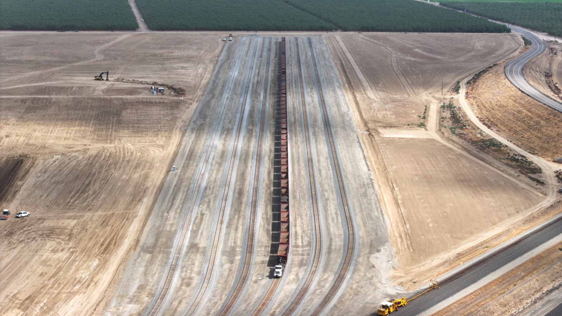 An aerial view of the newly completed 150-acre Southern Railhead Facility in Wasco, Kern County, featuring staging tracks for California High-Speed Rail materials.