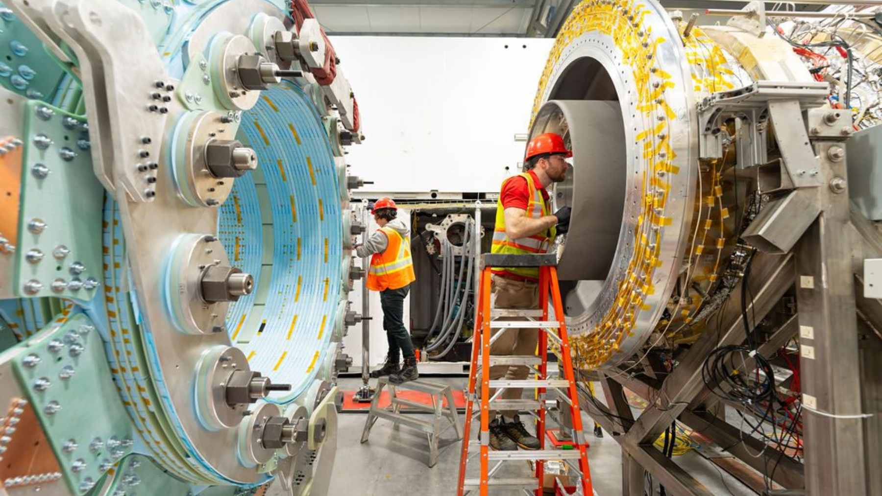 Engineers working on the complex metallic core of General Fusion's Magnetized Target Fusion reactor.