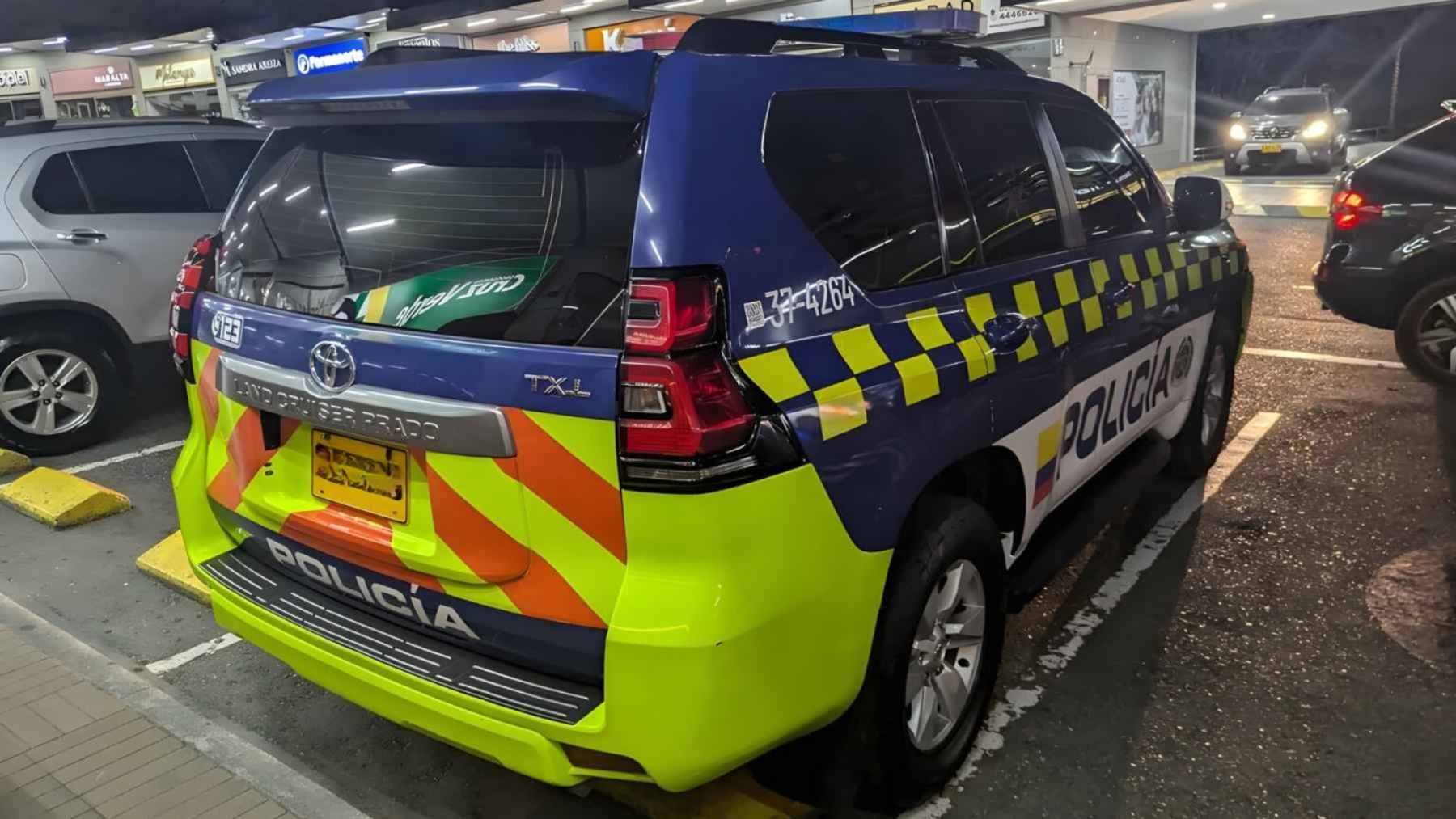 An armored Toyota Land Cruiser Prado diesel SUV used by the Colombian National Police driving on a city street.