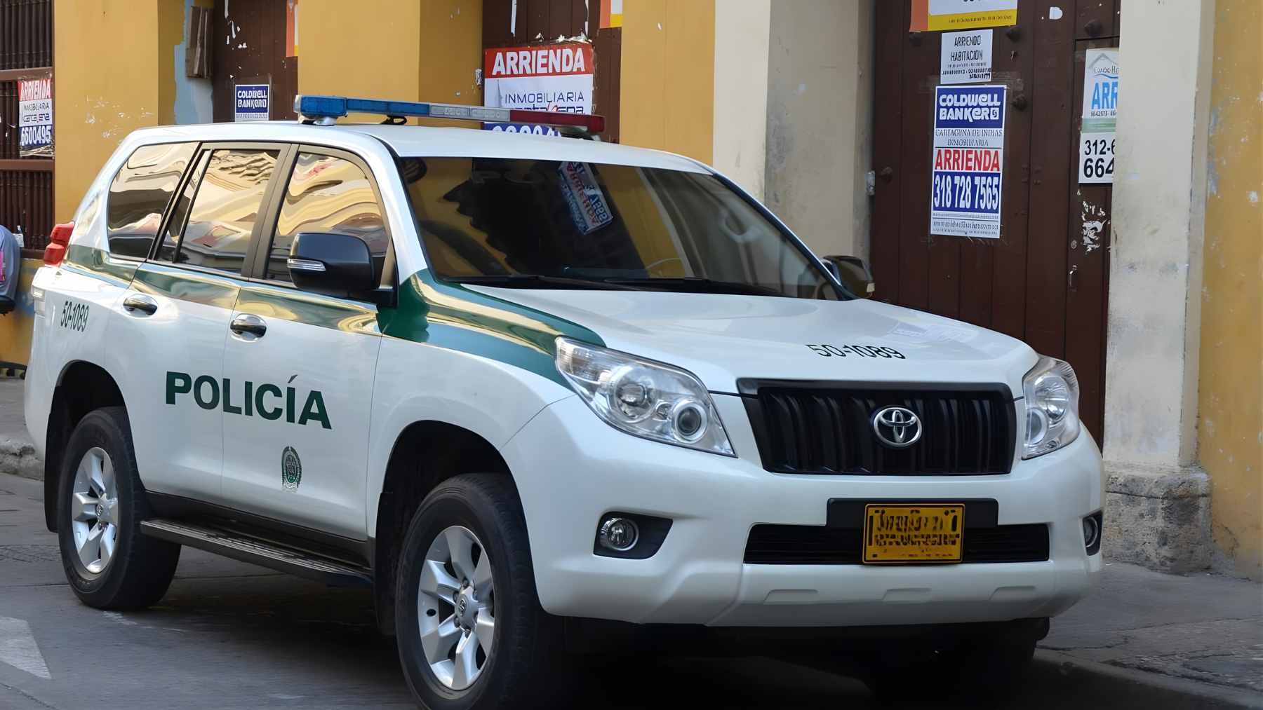An armored Toyota Land Cruiser Prado diesel SUV used by the Colombian National Police driving on a city street.