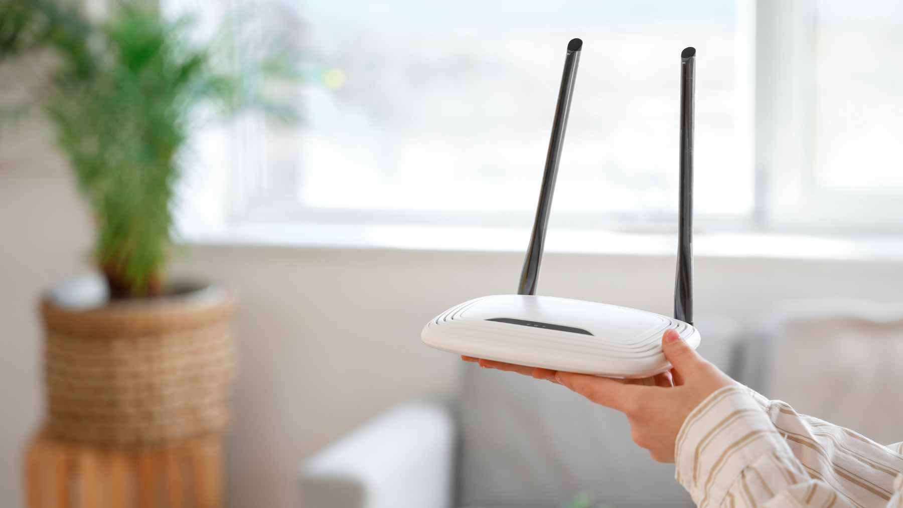 Goodbye to easy home Wi-Fi upgrades: the FCC just changed the router market in a way that may quietly shorten how long internet security feels safe 1 A close-up shot of a modern home Wi-Fi router with glowing indicator lights sitting on a wooden desk.
