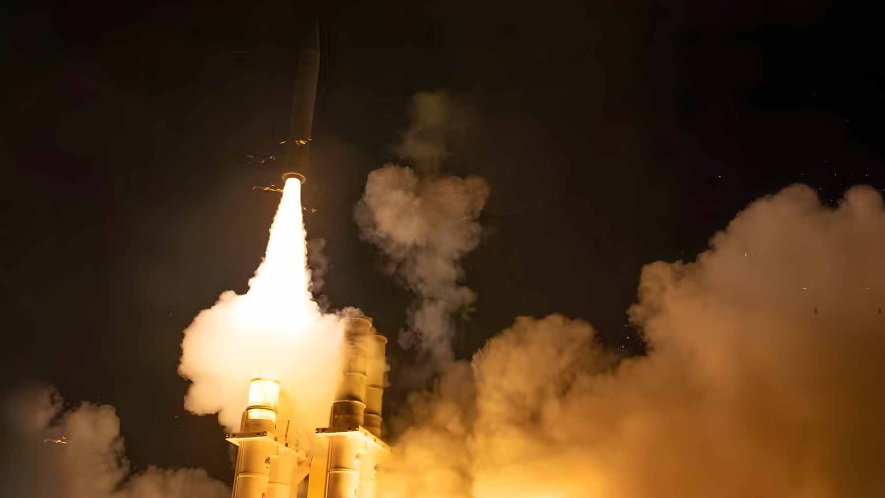An Arrow 3 interceptor missile launching into the sky from a military defense facility in Israel.
