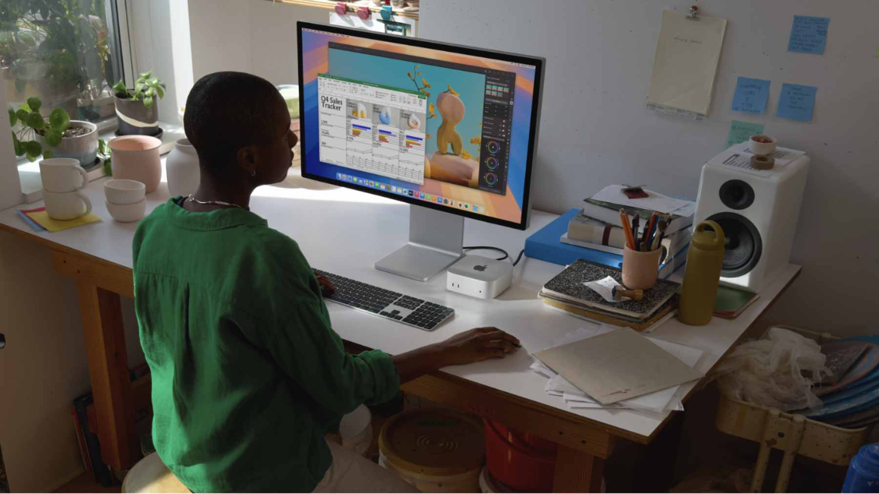 A silver Apple Mac mini connected via a Thunderbolt cable to a large external GPU enclosure.