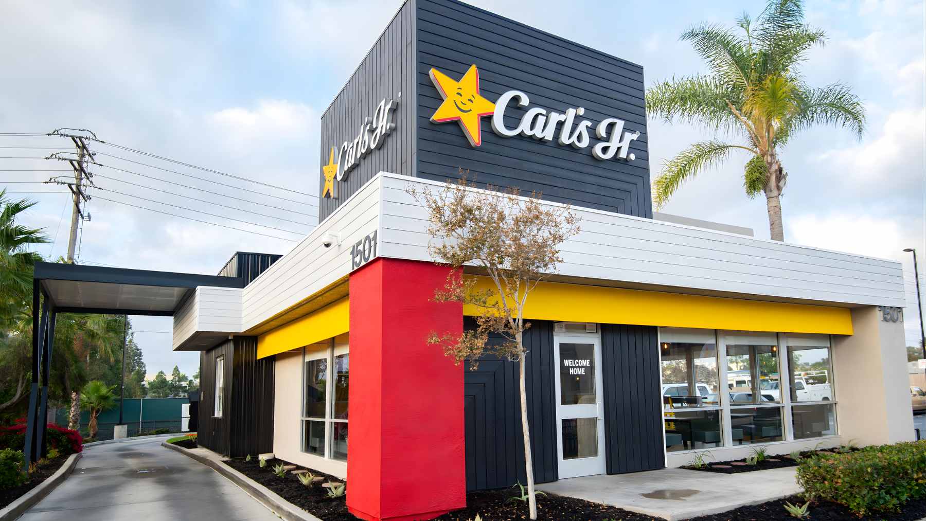 An exterior shot of a Carl's Jr. restaurant building under an overcast sky.