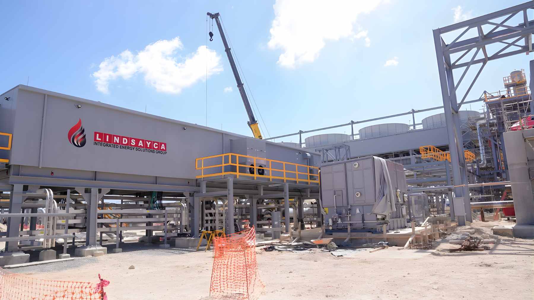 An aerial view of the Manzanillo Power Land combined-cycle natural gas plant in Montecristi, Dominican Republic, featuring the main turbines and storage infrastructure.