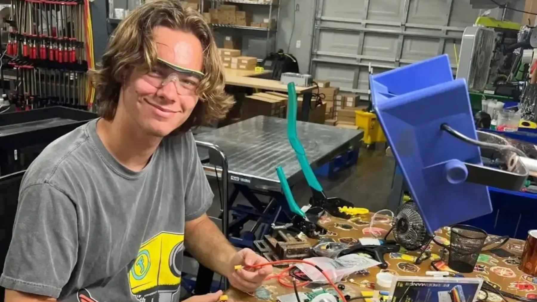 A portable, sleek lithium iron phosphate battery generator powering home appliances during a blackout.