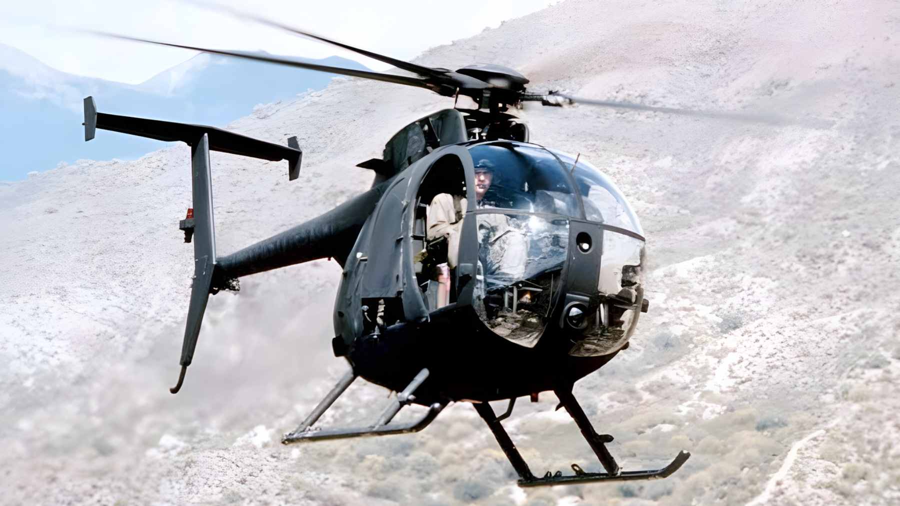 The tiny folding helicopter that looked too small for war became the key to an impossible rescue, and that is why the mission worked at all 1 A U.S. military MH-6 Little Bird helicopter operating in a muddy, austere environment.