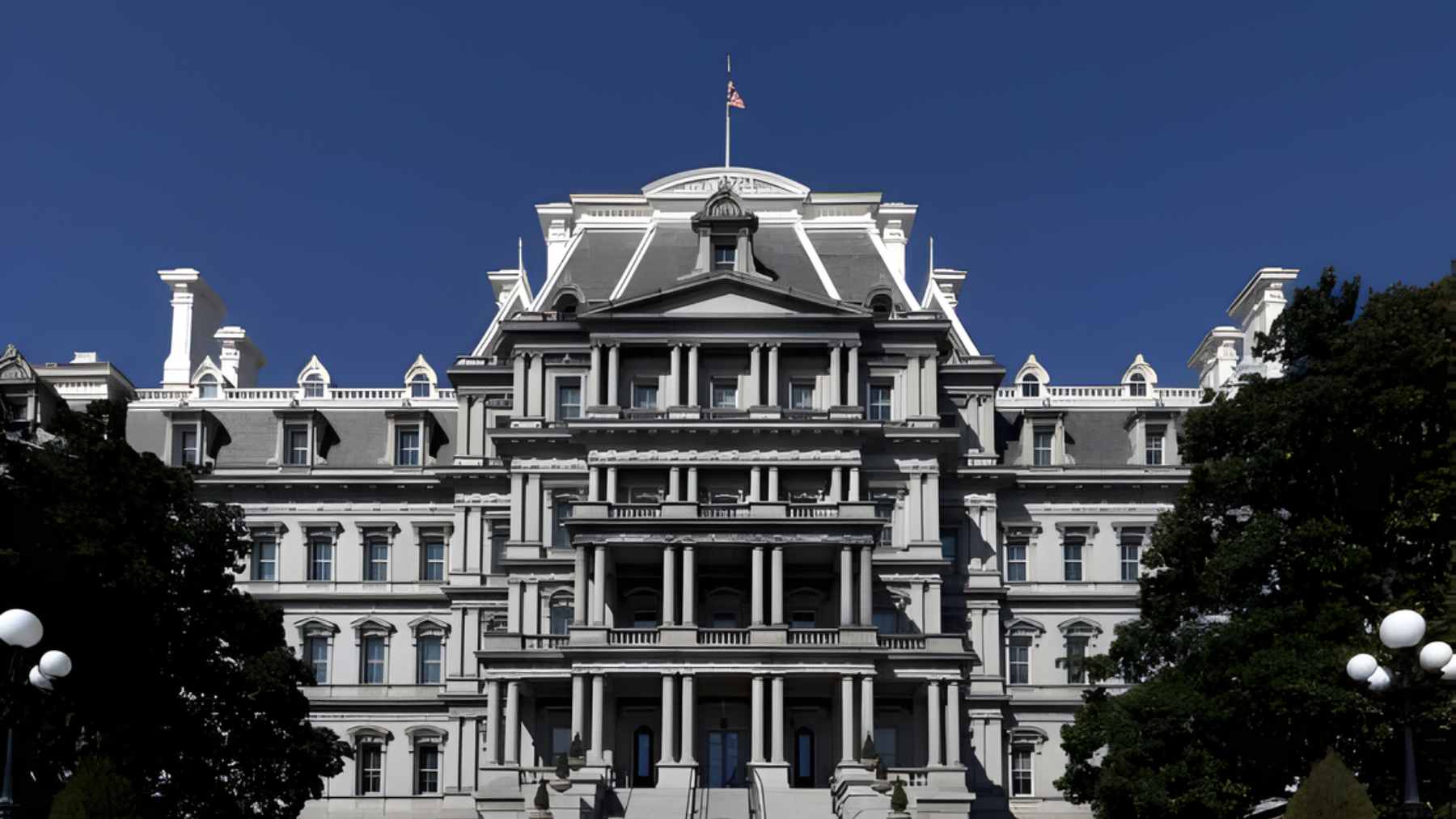 The historic, gray granite facade of the Eisenhower Executive Office Building situated next to the White House.
