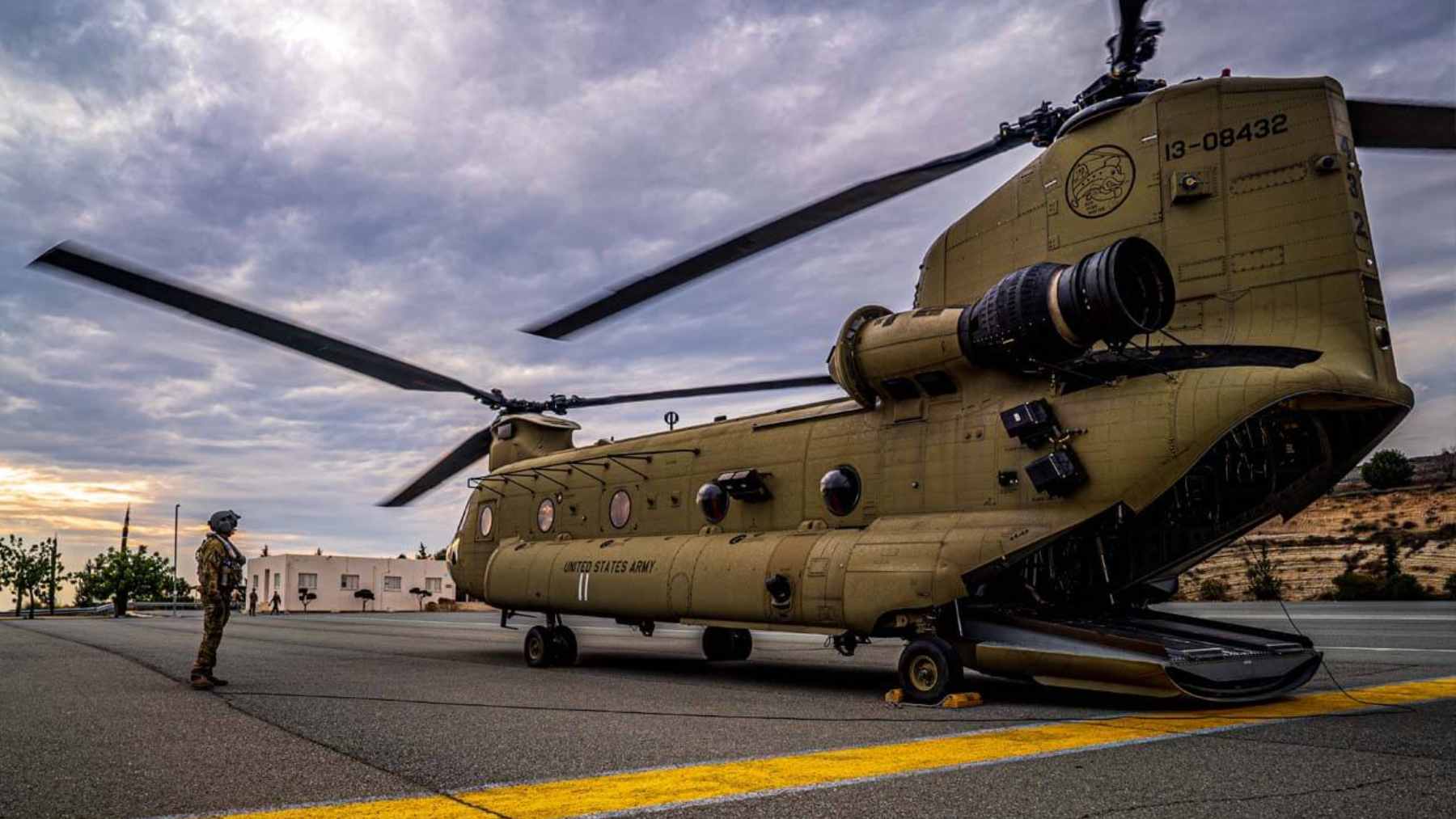 A U.S. Army CH-47F Chinook helicopter performing an automated landing in a dusty environment.