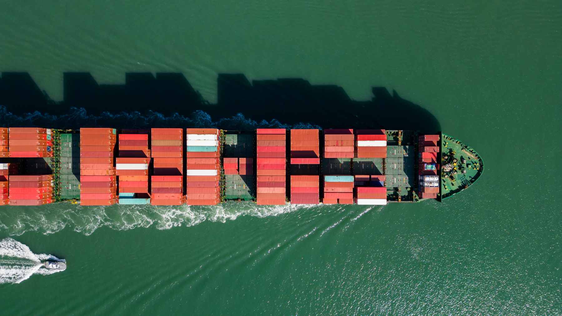 The U.S. aims to revolutionize maritime travel with ships capable of sailing for years without diesel or refueling 1 A massive commercial tanker ship sailing smoothly across the open ocean, leaving a white wake behind it.