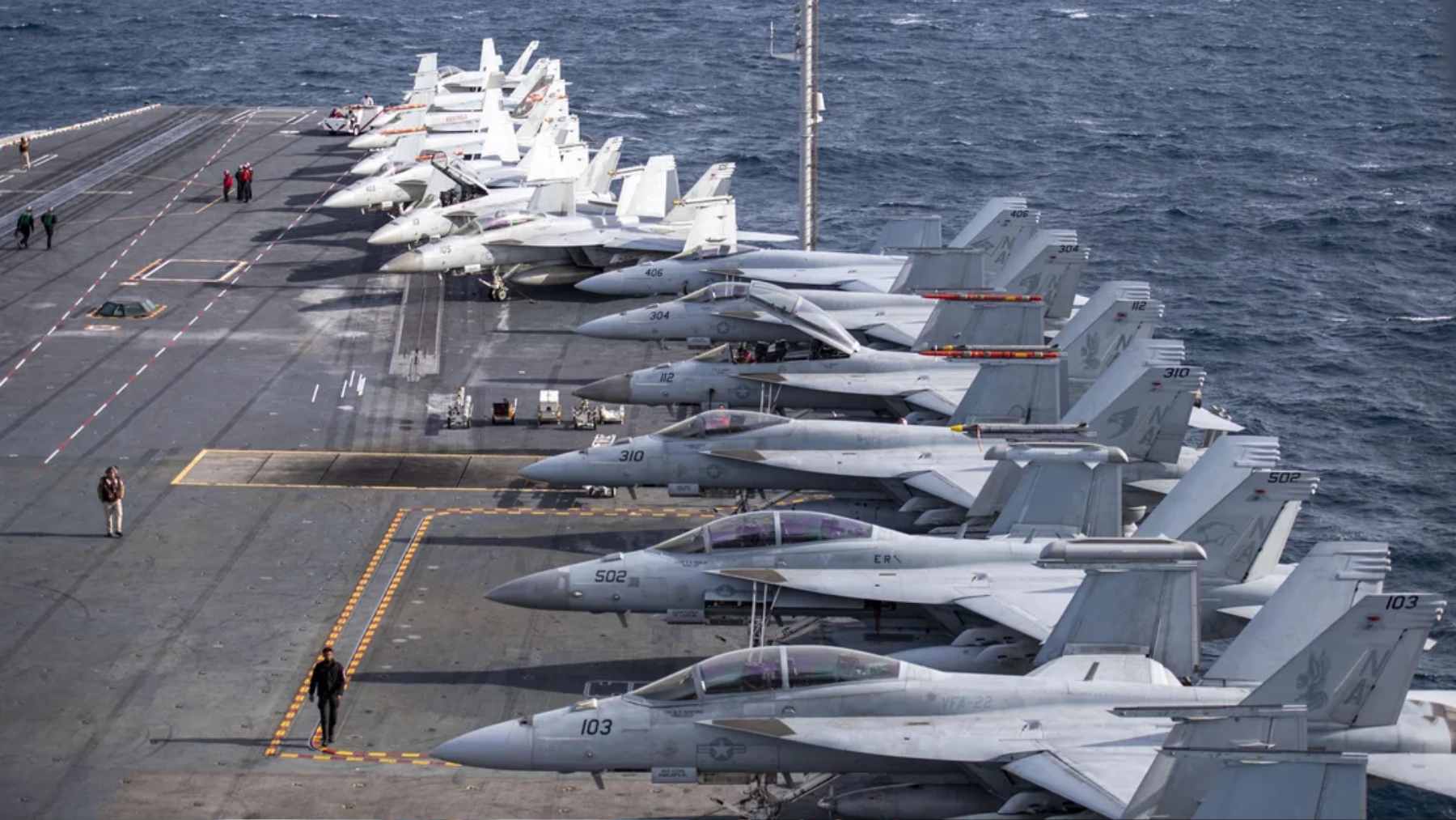 A U.S. military mechanic analyzing a grounded F-35 fighter jet, constrained by restrictive contractor repair agreements.