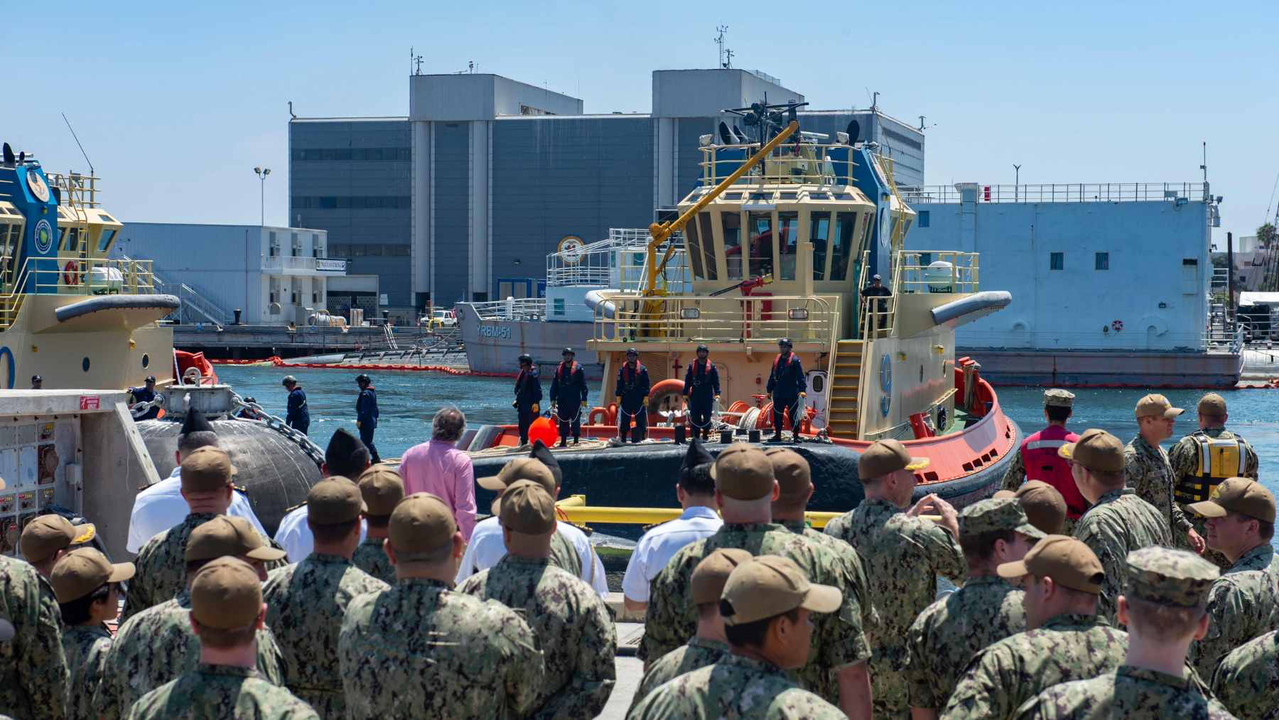An aerial view of the bustling Callao Naval Base in Peru, featuring military docks and heavy port infrastructure.